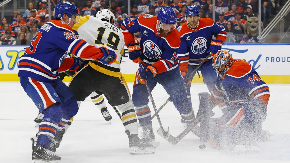 Oct 25, 2024; Edmonton, Alberta, CAN; Pittsburgh Penguins forward Cody Glass (19) looks for a loose puck in front of Edmonton Oilers goaltender Stuart Skinner (74) during the second period at Rogers Place. Mandatory Credit: Perry Nelson-Imagn Images