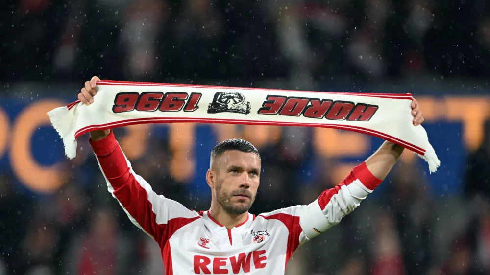 10 October 2024, North Rhine-Westphalia, Cologne: German footballer Lukas Podolski celebrates with the fans during the Lukas Podolski's farewell match. Photo: Federico Gambarini/dpa