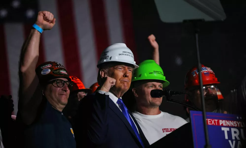 Endorsed by steel workers onstage, Republican presidential nominee and former U.S. President Donald Trump wears a hard hat during his Make America Great Again Rally in Latrobe, Pennsylvania, U.S. October 19, 2024. REUTERS/Brian Snyder