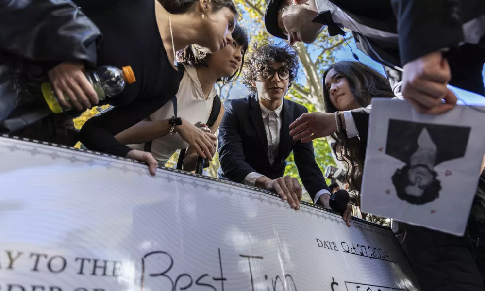 Anthony Po, right, deliberates with the judges at the Timothee Chalamet lookalike contest near Washington Square Park, Sunday, Oct. 27, 2024, in New York. (AP Photo/Stefan Jeremiah)