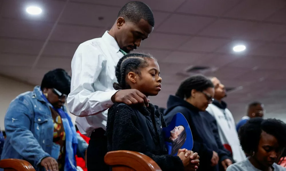 A child holds an image of Democratic presidential nominee U.S. Vice President Kamala Harris on the day of her visit at the Church of Christian Compassion, part of the "Souls to the Polls", as she campaigns in Philadelphia, Pennsylvania, U.S. October 27, 2024. REUTERS/Evelyn Hockstein   TPX IMAGES OF THE DAY