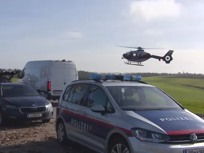 In this video grab provided by PULS 24 News TV, police vehicles and a police helicopter operate in the village of Fraunschalg near Altenfelden, Austria, Monday, Oct. 28, 2024, after people were fatally shot in the area. (PULS 24 News TV via AP)