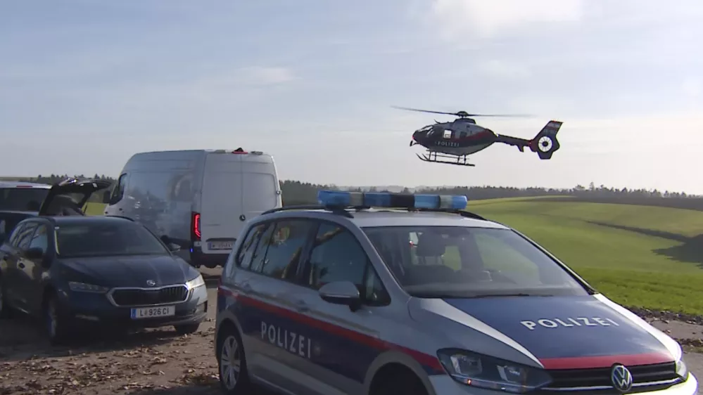 In this video grab provided by PULS 24 News TV, police vehicles and a police helicopter operate in the village of Fraunschalg near Altenfelden, Austria, Monday, Oct. 28, 2024, after people were fatally shot in the area. (PULS 24 News TV via AP)