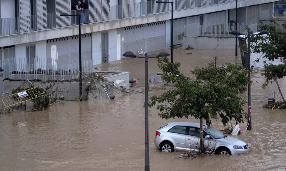 Cars are trapped by flooding in Valencia, Wednesday, Oct. 30, 2024. (AP Photo/Alberto Saiz)