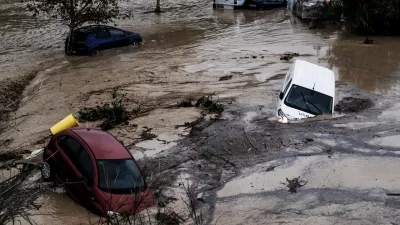 Cars are being swept away by the water, after floods preceded by heavy rains caused the river to overflow its banks in the town of Alora, Malaga, Spain, Tuesday, Oct. 29, 2024. (AP Photo/Gregorio Marrero)