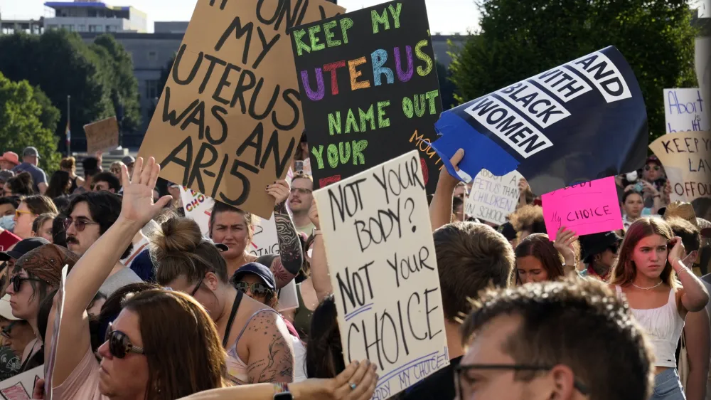 FILE - Protesters rally at the Ohio Statehouse in support of abortion rights after the U.S. Supreme Court overturned Roe vs. Wade, June 24, 2022, in Columbus, Ohio. Ohio's constitution is caught in a tug-of-war. With an effort to enshrine abortion rights looming this fall, an influential mix of Republican politicians, lobbying organizations and business interests is working to make another change to the state's founding document first. They are pushing an amendment raising the threshold for passing future constitutional changes to 60% of Ohio voters from 50%-plus-one. (Barbara J. Perenic/The Columbus Dispatch via AP, File)