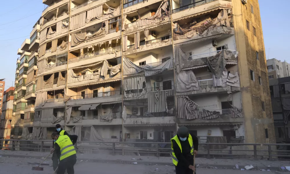 Workers remove the rubble in front of a damaged building that was hit by an Israeli airstrike on Dahiyeh, in the southern suburb of Beirut, Lebanon, Friday, Nov. 1, 2024. (AP Photo/Hussein Malla)