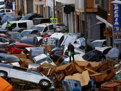 A man stands next to stranded cars, following floods in Sedavi, Valencia, Spain, October 31, 2024. REUTERS/Susana Vera   TPX IMAGES OF THE DAY