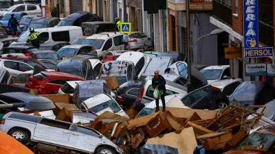 A man stands next to stranded cars, following floods in Sedavi, Valencia, Spain, October 31, 2024. REUTERS/Susana Vera   TPX IMAGES OF THE DAY