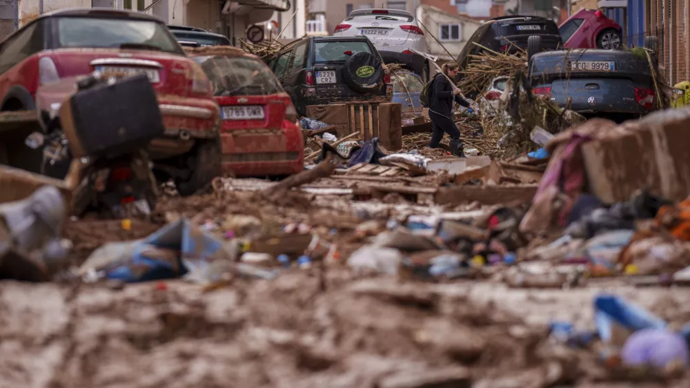 A man walks through a street affected by floods in Valencia, Spain, Saturday, Nov. 2, 2024. (AP Photo/Manu Fernandez)