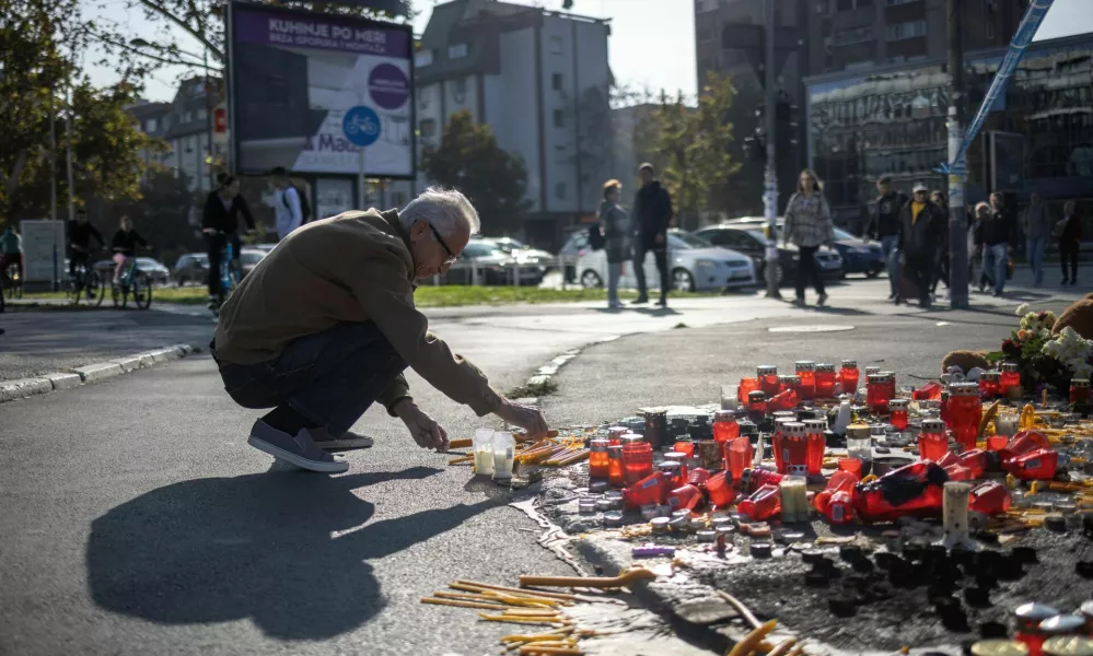 A man lights a candle to pay his respects to the people who died when a part of the roof collapsed at a railway station in Novi Sad, Serbia November 2, 2024. REUTERS/Marko Djurica