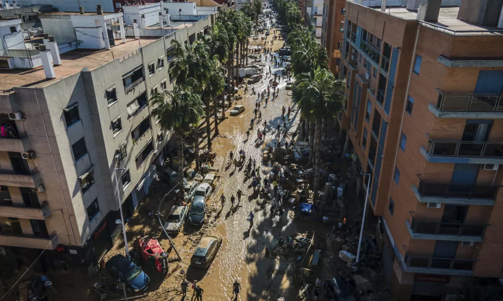 Volunteers and residents clean the mud four days after flash floods swept away everything in their path in Paiporta, outskirts of Valencia, Spain, Saturday, Nov. 2, 2024.(AP Photo/Angel Garcia)