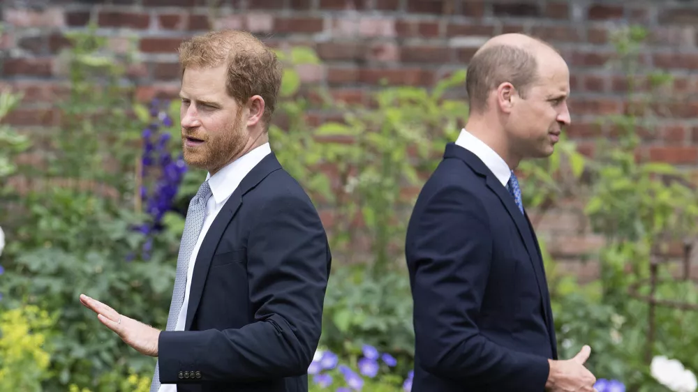 FILE - Prince Harry, left, and Prince William stand together during the unveiling of a statue they commissioned of their mother Princess Diana, on what would have been her 60th birthday, in the Sunken Garden at Kensington Palace, London, Thursday July 1, 2021. Prince Harry has said he wants to have his father and brother back and that he wants "a family, not an institution," during a TV interview ahead of the publication of his memoir. The interview with Britain's ITV channel is due to be released this Sunday. (Dominic Lipinski /Pool Photo via AP, File)