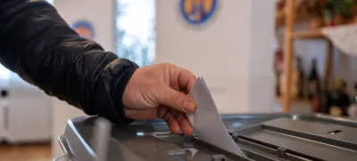 03 November 2024, Berlin: A man casts a ballot in the ballot box at the embassy of the Republic of Moldova for the 2024 Moldovan presidential run-off election. Photo: Christophe Gateau/dpa