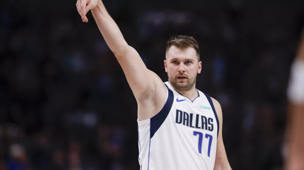 Dallas Mavericks guard Luka Doncic (77) celebrates after a 3-point basket during the first half of an NBA basketball game against the Orlando Magic, Sunday, Nov. 3, 2024, in Dallas. (AP Photo/Gareth Patterson)