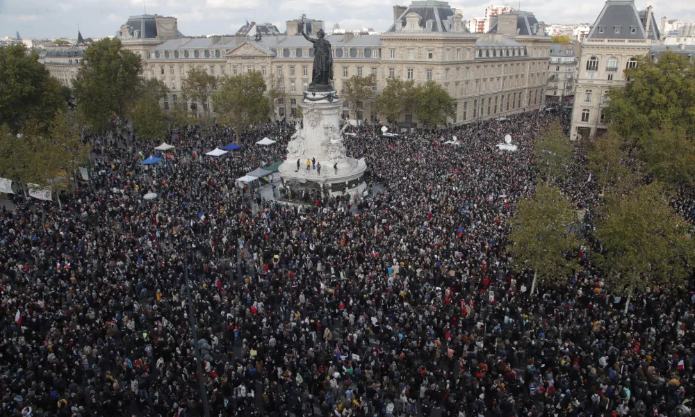 FILE - Hundreds of people gather on Republique square during a demonstration Sunday Oct. 18, 2020 in Paris, in support of freedom of speech and to pay tribute to French history teacher Samuel Paty. (AP Photo/Michel Euler, File)