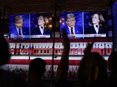 Viewers cheer as they watch a debate between Democratic presidential nominee Vice President Kamala Harris and Republican presidential nominee former President Donald Trump at the Angry Elephant Bar and Grill, Tuesday, Sept. 10, 2024, in San Antonio. (AP Photo/Eric Gay)