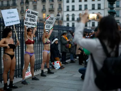 Women in underwear hold placards in support of an Iranian female student, named as Ahoo Daryaei on social media, seen in her underwear at a Tehran university in protest against country's strict Islamic dress code, and all Iranian women who fight for freedom, during a rally in front of the Pantheon in Paris, France, November 5, 2024. The slogans read "Alliance of Women for Democracy", "To the rebellious Iranian women, grateful women" and "Woman, Life, Freedom". REUTERS/Stephanie Lecocq