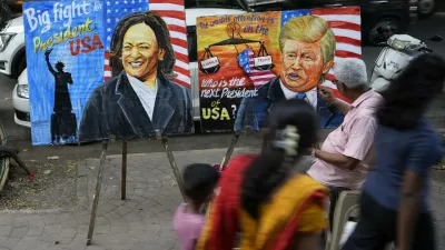 Art teacher Prithviraj Kambli paints posters of US Vice President Kamala Harris and former US President Donald Trump outside his school in Mumbai, India, Tuesday, Nov. 5, 2024. (AP Photo/Rajanish Kakade)