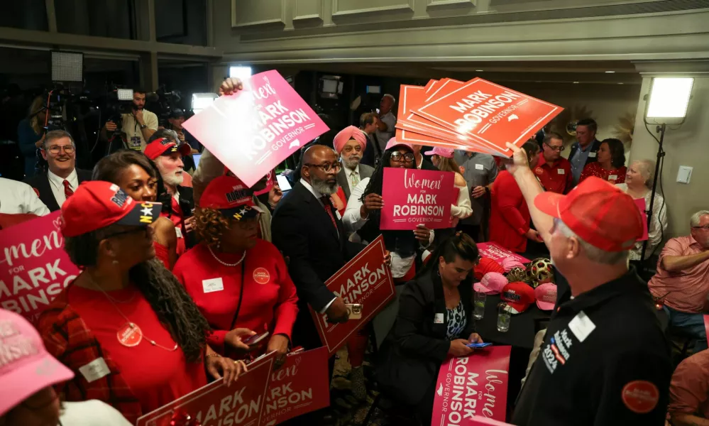 Supporters of Republican candidate for governor of North Carolina Mark Robinson hold up signs, following results on Election Day during the 2024 U.S. presidential election, at the Raleigh City Club in Raleigh, North Carolina, U.S., November 5, 2024. REUTERS/Sam Wolfe