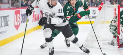 Nov 5, 2024; Saint Paul, Minnesota, USA; Los Angeles Kings center Anze Kopitar (11) skates after the puck against the Minnesota Wild defenseman Brock Faber (7) in the first period at Xcel Energy Center. Mandatory Credit: Brad Rempel-Imagn Images