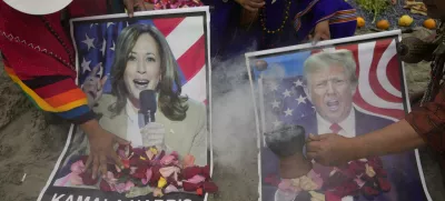 Shamans perform a good luck ritual holding posters of Democratic presidential nominee Vice President Kamala Harris and Republican presidential nominee former President Donald Trump, at the beach in Lima, Peru, Tuesday, Nov. 5, 2024. (AP Photo/Martin Mejia)