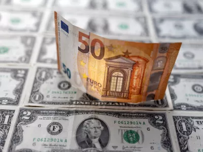 A Euro banknote is displayed on U.S. Dollar banknotes in this illustration taken, February 14, 2022. REUTERS/Dado Ruvic/Illustration