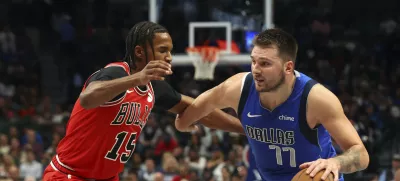 Chicago Bulls forward Julian Phillips (15) defends as Dallas Mavericks guard Luka Doncic (77) drives the ball past in the second half of an NBA basketball game Wednesday, Nov. 6, 2024, in Dallas. (AP Photo/Richard W. Rodriguez)