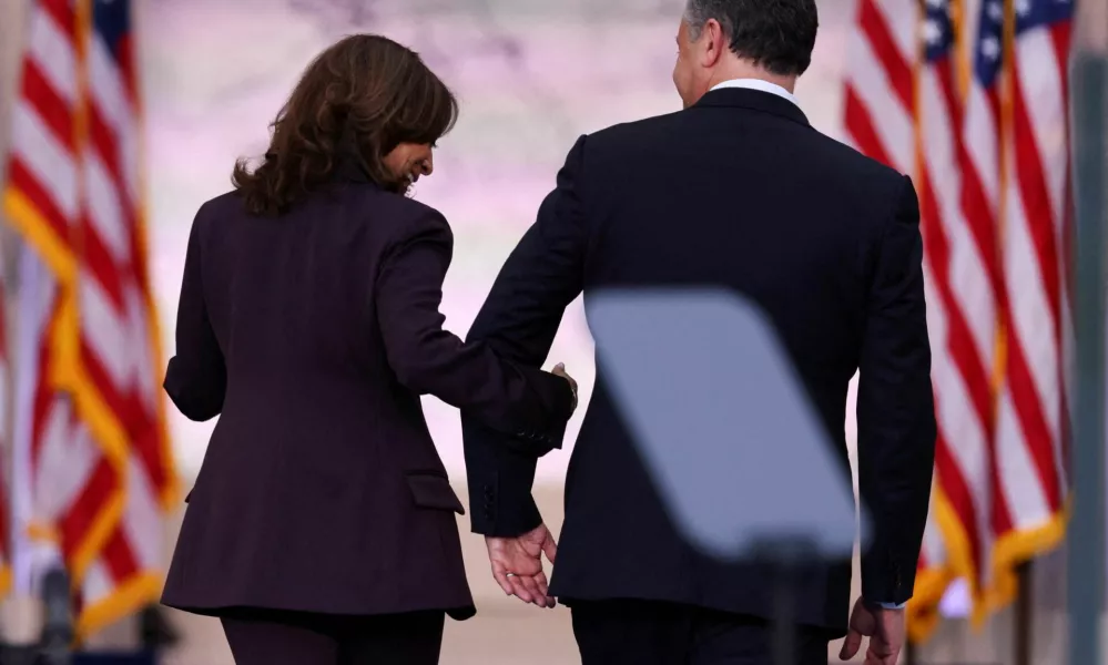 Democratic presidential nominee U.S. Vice President Kamala Harris and her husband Second gentleman Doug Emhoff leave the stage after she delivered remarks, conceding the 2024 U.S. presidential election to President-elect Donald Trump, at Howard University in Washington, U.S., November 6, 2024. REUTERS/Mike Blake   TPX IMAGES OF THE DAY