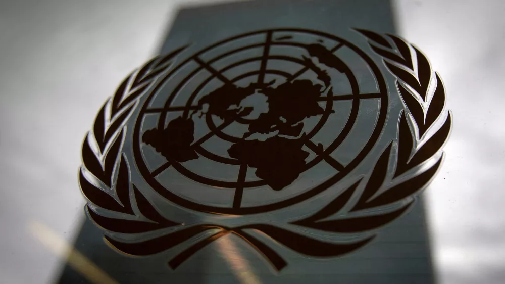 FILE PHOTO: The United Nations headquarters building is pictured though a window with the UN logo in the foreground in the Manhattan borough of New York August 15, 2014. REUTERS/Carlo Allegri/File Photo