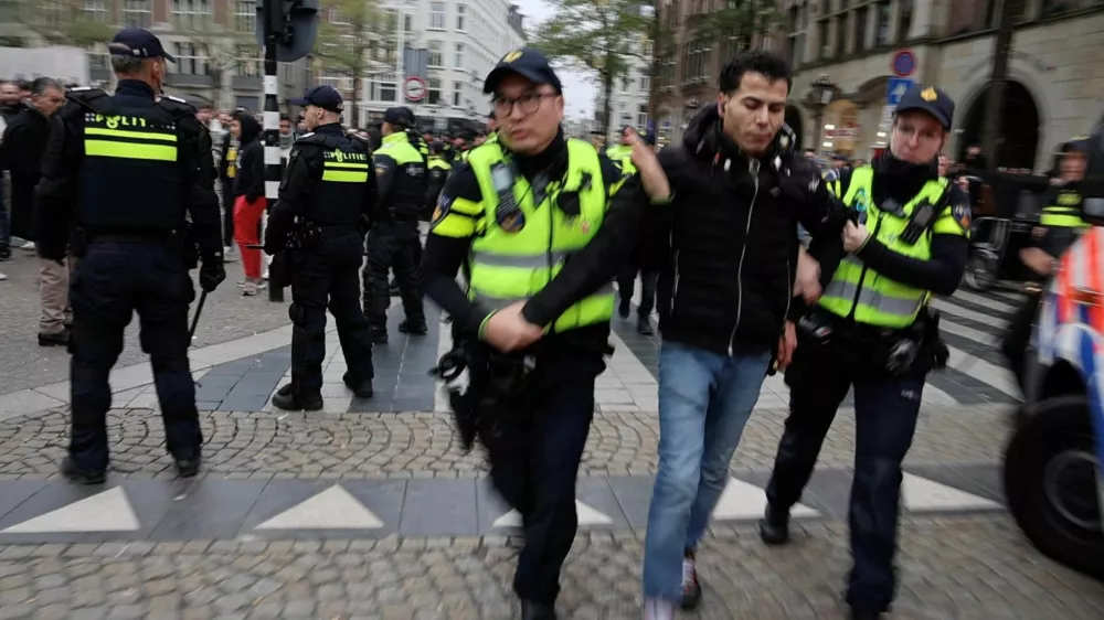 A person is detained by the police as Israeli Maccabi Tel Aviv supporters demonstrate in Amsterdam, Netherlands, November 7, 2024, in this screengrab obtained from a social media video. Michel Van Bergen/via REUTERS THIS IMAGE HAS BEEN SUPPLIED BY A THIRD PARTY. MANDATORY CREDIT.