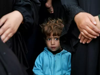 A child looks on as people mourn Palestinians killed in Israeli strikes, at Nasser hospital in Khan Younis in the southern Gaza Strip November 9, 2024. REUTERS/Hatem Khaled   TPX IMAGES OF THE DAY