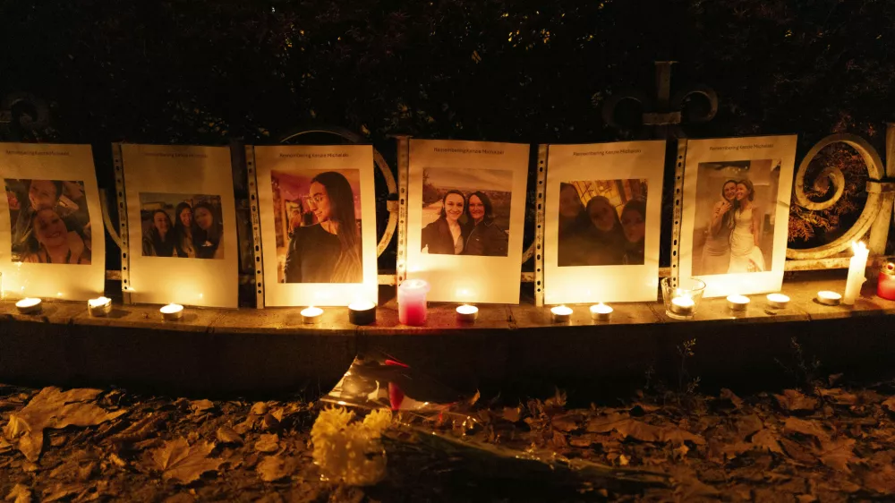 Photos showing Mackenzie Michalski, an 31-year-old American tourist who was murdered while on vacation, hang at a candlelight vigil in Budapest, Hungary, Saturday, Nov. 9, 2024. (AP Photo/Bela Szandelszky)