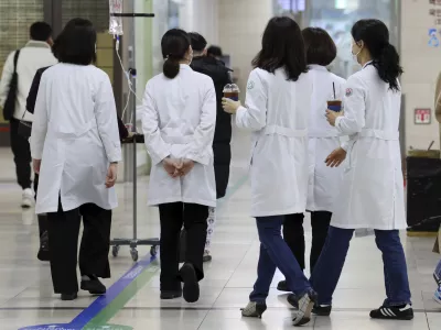 Medical workers walk inside a general hospital in Gwangju, South Korea, Monday, Feb. 19, 2024. Trainee doctors in South Korea began resigning en masse Monday in protest of a government medical policy, causing reported delays in surgeries and other treatments at hospitals though no major disruption in the country's medical service has yet occurred.(Chun Jung-in/Yonhap via AP)