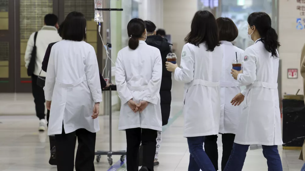 Medical workers walk inside a general hospital in Gwangju, South Korea, Monday, Feb. 19, 2024. Trainee doctors in South Korea began resigning en masse Monday in protest of a government medical policy, causing reported delays in surgeries and other treatments at hospitals though no major disruption in the country's medical service has yet occurred.(Chun Jung-in/Yonhap via AP)