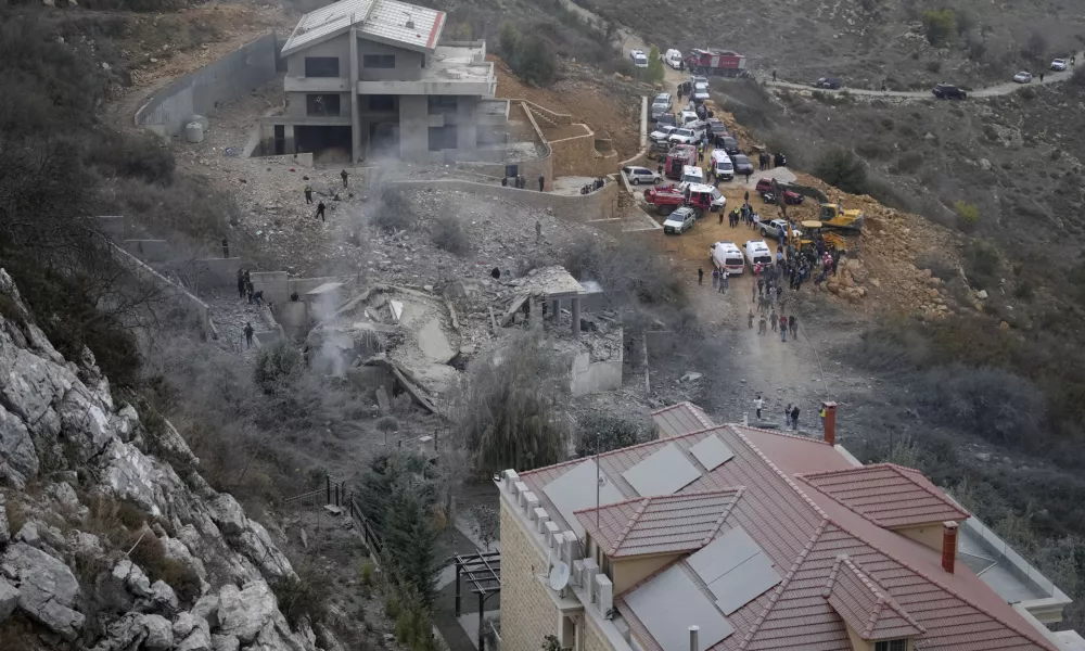 Rescue workers search for victims at a house hit in an Israeli airstrike in Baalchmay village east of Beirut, Lebanon, Tuesday, Nov. 12, 2024. (AP Photo/Hassan Ammar)