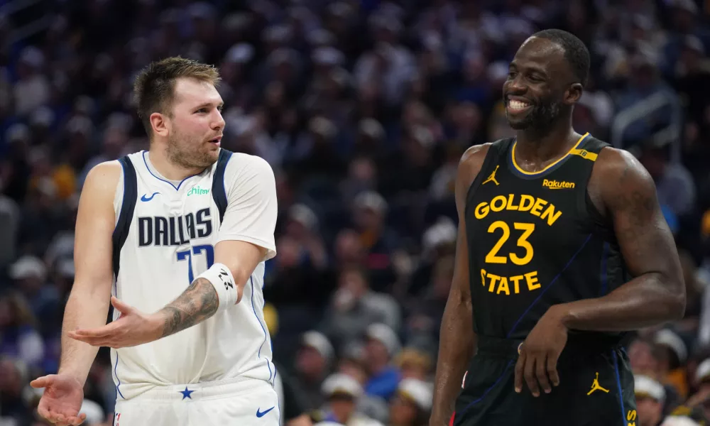 Nov 12, 2024; San Francisco, California, USA; Dallas Mavericks guard Luka Doncic (77) talks with Golden State Warriors forward Draymond Green (23) after being called for a foul in the fourth quarter at the Chase Center. Mandatory Credit: Cary Edmondson-Imagn Images