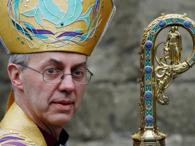 FILE PHOTO: Justin Welby leaves after his enthronement ceremony as Archbishop of Canterbury at Canterbury Cathedral, in Canterbury, southern England March 21, 2013. REUTERS/Luke MacGregor/File Photo