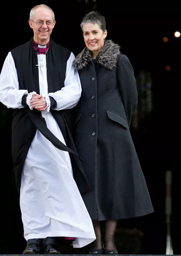 FILE PHOTO: Justin Welby, the new Archbishop of Canterbury, stands on the steps with his wife Caroline after a ceremony at St Paul's Cathedral in central London, Britain February 4, 2013. REUTERS/Andrew Winning/File Photo