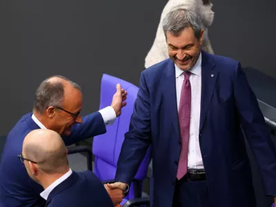 German opposition leader Friedrich Merz of the Christian Democratic Union party (CDU) and Bavarian State Prime Minister Markus Soeder of the Christian Social Union (CSU) shake hands at the lower house of parliament, the Bundestag, in Berlin, Germany November 13, 2024. REUTERS/Lisi Niesner