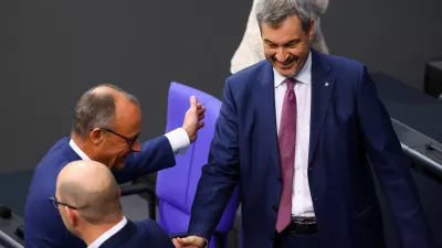 German opposition leader Friedrich Merz of the Christian Democratic Union party (CDU) and Bavarian State Prime Minister Markus Soeder of the Christian Social Union (CSU) shake hands at the lower house of parliament, the Bundestag, in Berlin, Germany November 13, 2024. REUTERS/Lisi Niesner