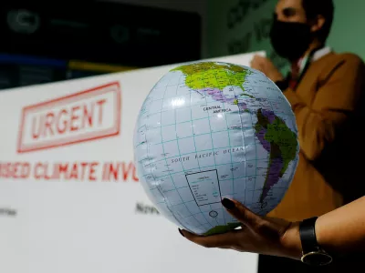 An activist holds up a prop representing the earth at a protest during the United Nations Climate Change Conference (COP29), in Baku, Azerbaijan November 14, 2024. REUTERS/Maxim Shemetov