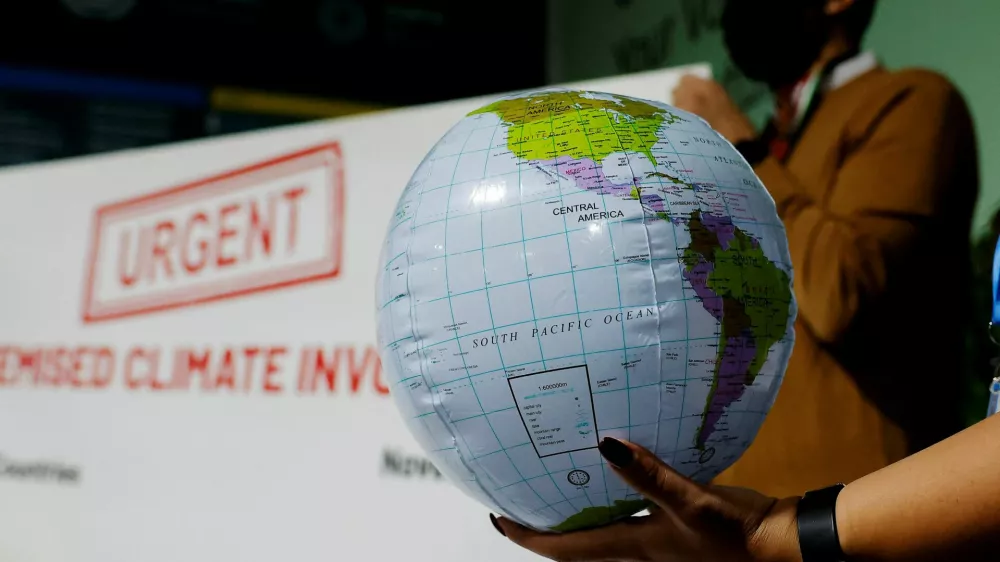 An activist holds up a prop representing the earth at a protest during the United Nations Climate Change Conference (COP29), in Baku, Azerbaijan November 14, 2024. REUTERS/Maxim Shemetov