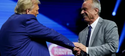 FILE PHOTO: Robert F. Kennedy Jr. and Republican presidential candidate and former U.S. President Donald Trump greet each other at a campaign event sponsored by conservative group Turning Point USA, in Duluth, Georgia, U.S., October 23, 2024. REUTERS/Carlos Barria/File Photo/File Photo