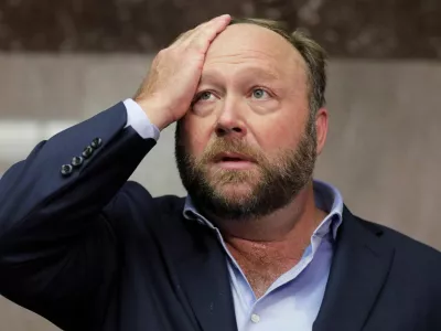 FILE PHOTO: Alex Jones of Infowars talks to the media before a Senate Intelligence Committee hearing on Capitol Hill in Washington, U.S., September 5, 2018. REUTERS/Jim Bourg/File Photo