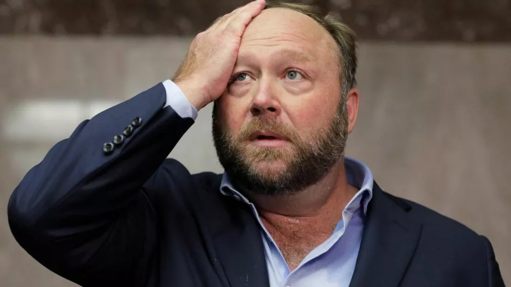 FILE PHOTO: Alex Jones of Infowars talks to the media before a Senate Intelligence Committee hearing on Capitol Hill in Washington, U.S., September 5, 2018. REUTERS/Jim Bourg/File Photo