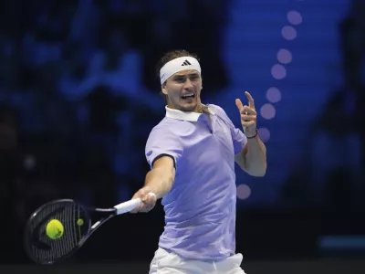 Germany's Alexander Zverev returns the ball to Spain's Carlos Alcaraz during their singles tennis match of the ATP World Tour Finals at the Inalpi Arena, in Turin, Italy, Friday, Nov. 15, 2024. (AP Photo/Antonio Calanni)