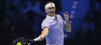 Germany's Alexander Zverev returns the ball to Spain's Carlos Alcaraz during their singles tennis match of the ATP World Tour Finals at the Inalpi Arena, in Turin, Italy, Friday, Nov. 15, 2024. (AP Photo/Antonio Calanni)