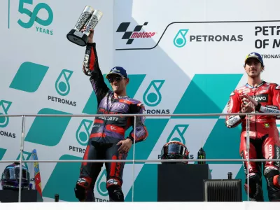 FILE PHOTO: MotoGP - Malaysian Grand Prix - Sepang International Circuit, Sepang, Malaysia - November 3, 2024 Prima Pramac Racing's Jorge Martin celebrates with his trophy on the podium after finishing second in the MotoGP as winner Ducati Lenovo Team's Francesco Bagnaia looks on REUTERS/Hasnoor Hussain/File Photo