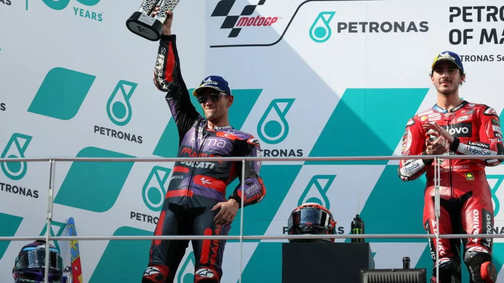 FILE PHOTO: MotoGP - Malaysian Grand Prix - Sepang International Circuit, Sepang, Malaysia - November 3, 2024 Prima Pramac Racing's Jorge Martin celebrates with his trophy on the podium after finishing second in the MotoGP as winner Ducati Lenovo Team's Francesco Bagnaia looks on REUTERS/Hasnoor Hussain/File Photo